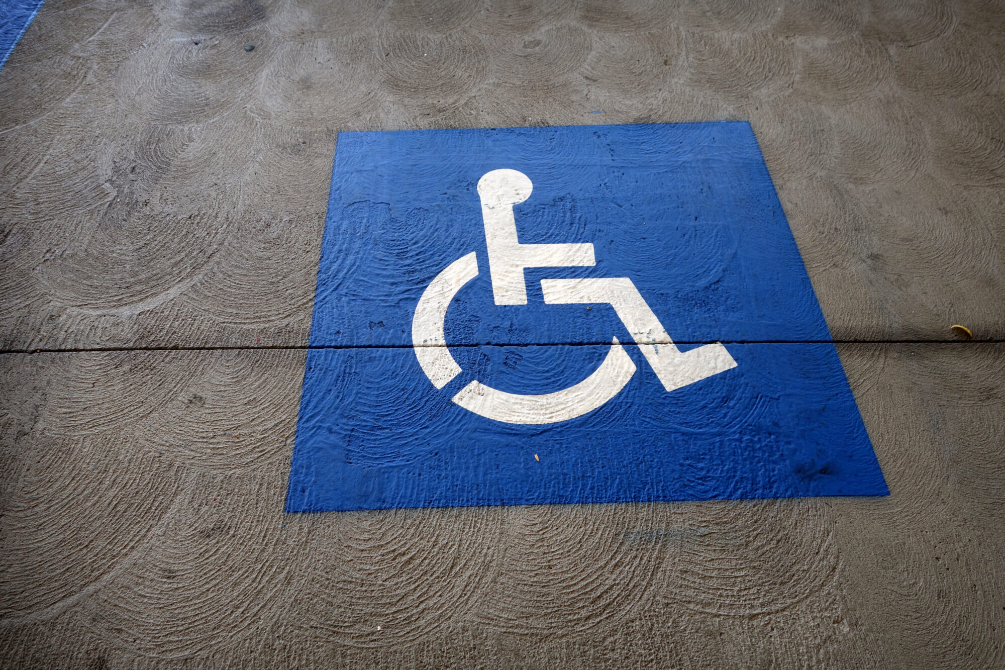 handicap symbol parking sign on street